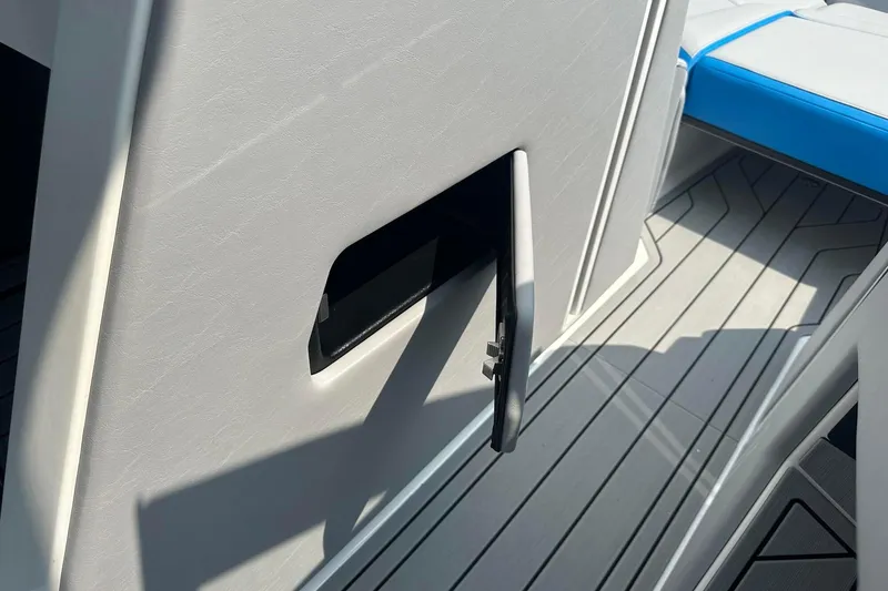 Slide: The Image of 2025 Nautique Super Air Nautique G23 interior detail with open storage compartment. - 22