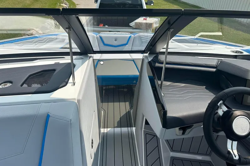 Slide: The Image of 2025 Nautique Super Air Nautique G23 interior with sleek seating and modern steering wheel design. - 30