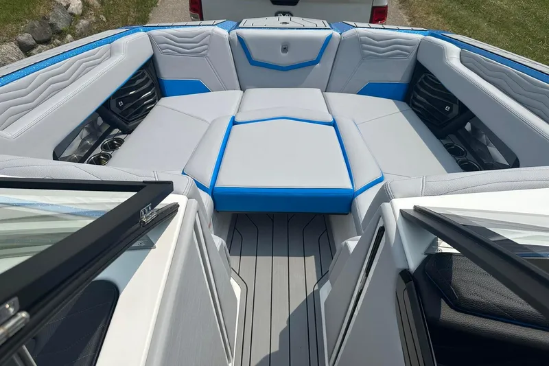 Slide: The Image of 2025 Nautique Super Air Nautique G23 boat interior with gray and blue seating. - 31
