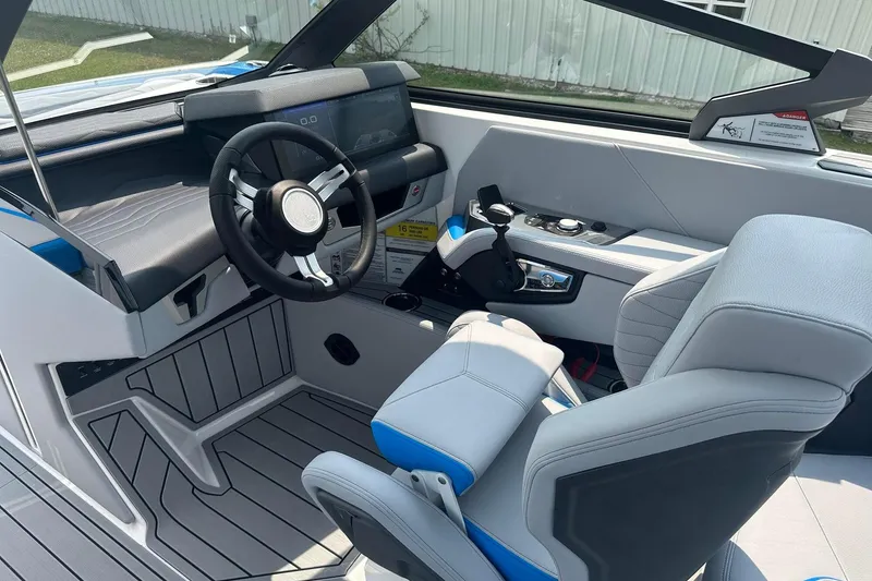 Slide: The Image of 2025 Nautique Super Air Nautique G23 cockpit with modern steering and controls. - 32