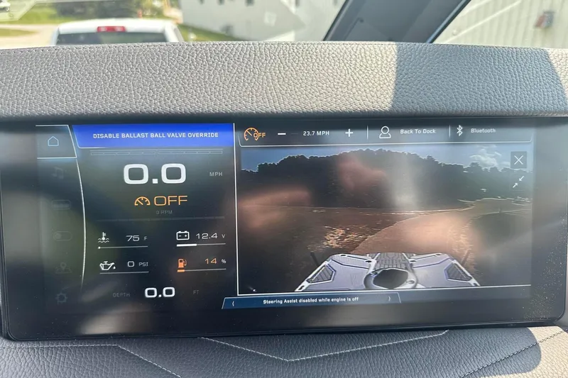 Slide: The Image of 2025 Nautique Super Air Nautique G23 dashboard display with speed, temperature, and camera view. - 34