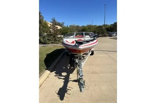 Slide: The Image of 2004 Tahoe Q-4 boat on trailer, parked on a sunny driveway. - 4