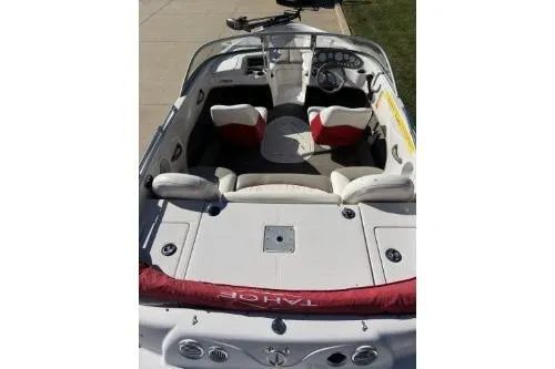 Slide: The Image of 2004 Tahoe Q-4 boat interior with seating and dashboard, parked on pavement. - 5
