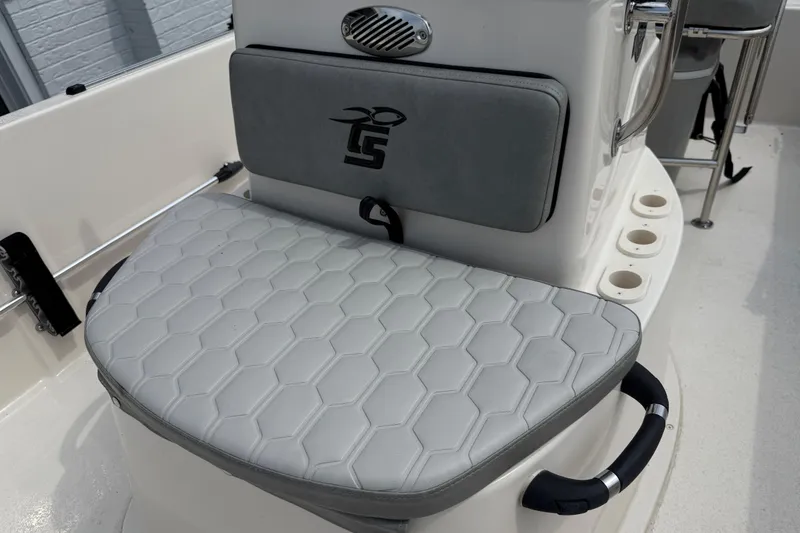 Slide: The Image of 2025 Carolina Skiff 192 JLS boat seat with hexagonal pattern and integrated rod holders. - 4