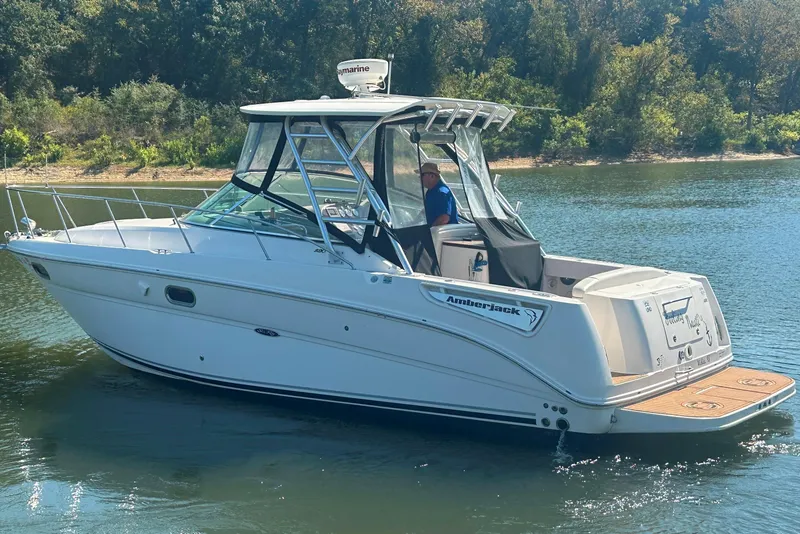 Slide: The Image of 2008 Sea Ray 290 Amberjack boat cruising on a calm lake. - 11