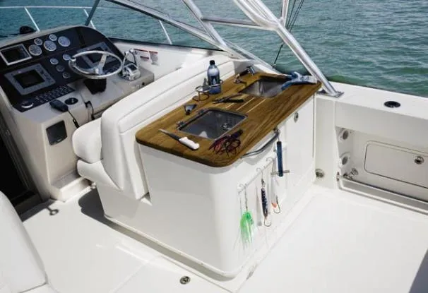 Slide: The Image of 2008 Sea Ray 290 Amberjack helm with steering wheel, gauges, and white seating. - 19