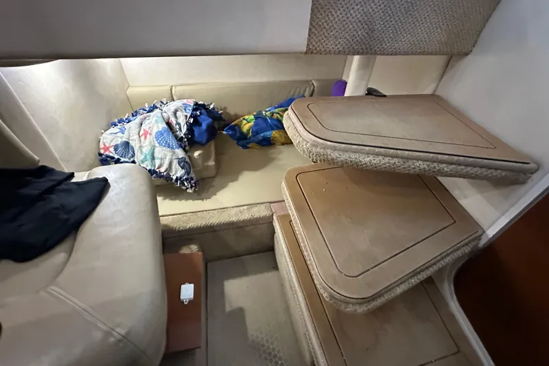 Slide: The Image of Interior cabin of 2008 Sea Ray 290 Amberjack with cozy seating and colorful blankets. - 24