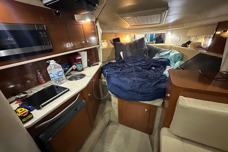 Slide: The Image of Interior of 2008 Sea Ray 290 Amberjack with cozy cabin and kitchenette. - 27