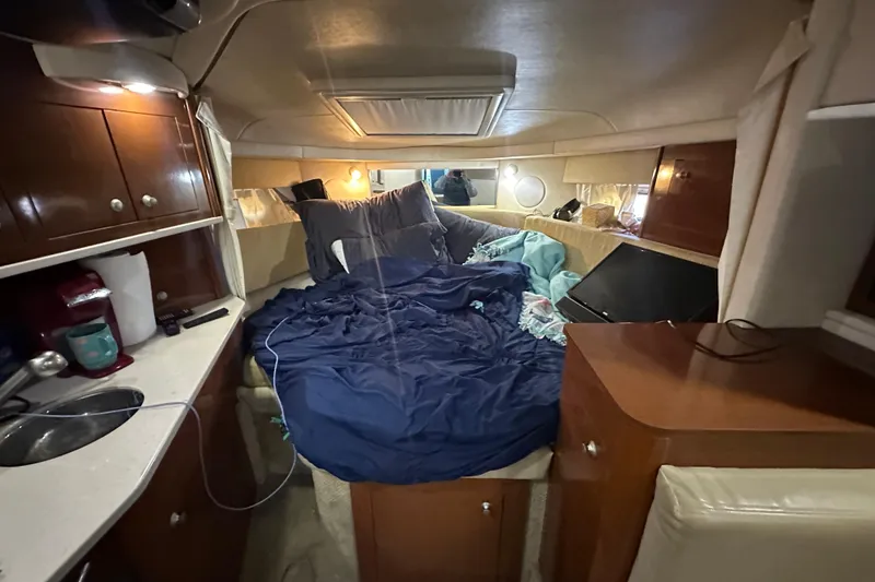 Slide: The Image of Interior cabin of 2008 Sea Ray 290 Amberjack with cozy bedding and wooden cabinetry. - 28