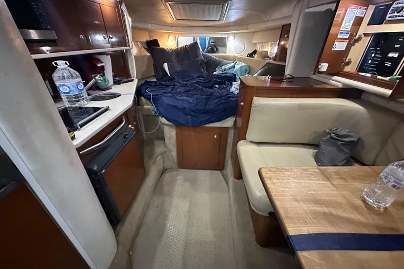 Slide: The Image of 2008 Sea Ray 290 Amberjack cabin interior with kitchenette, seating, and sleeping area. - 31