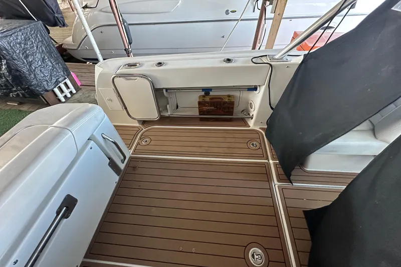 Slide: The Image of 2008 Sea Ray 290 Amberjack boat interior with teak flooring and storage compartments. - 35