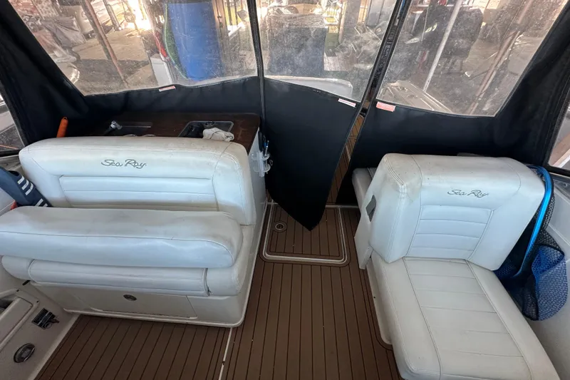 Slide: The Image of 2008 Sea Ray 290 Amberjack interior with white seating and wood flooring. - 37