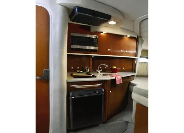 Slide: The Image of 2008 Sea Ray 290 Amberjack boat on calm water, surrounded by lush greenery. - 4