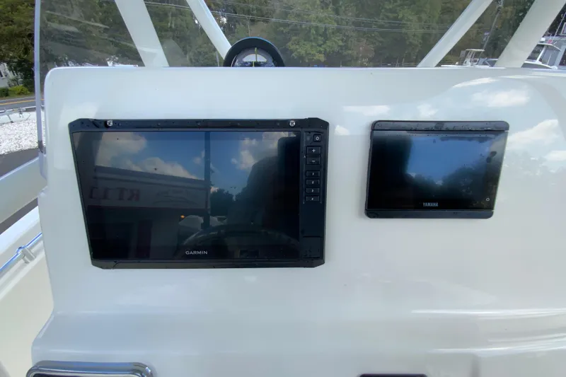 Slide: The Image of 2025 Cobia 220 Center Console dashboard with Garmin and Yamaha displays. - 15