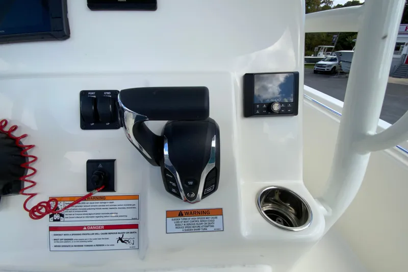 Slide: The Image of 2025 Cobia 220 Center Console boat dashboard with controls and audio system. - 16