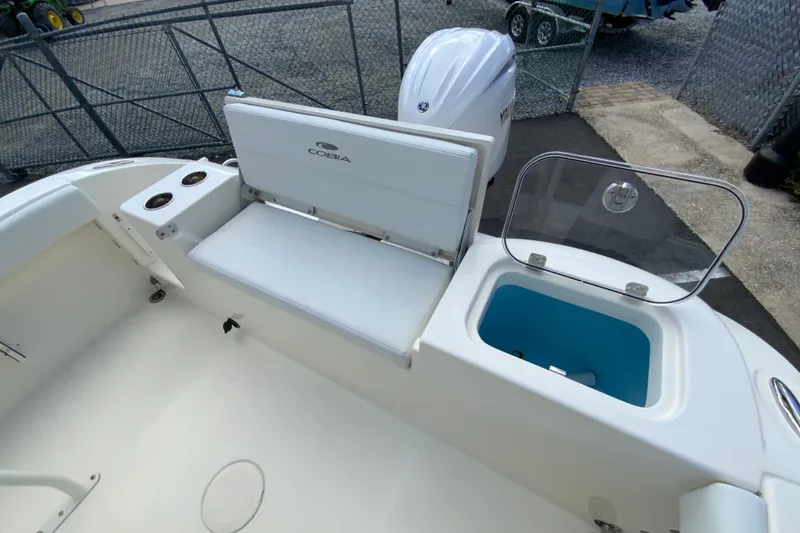 Slide: The Image of 2025 Cobia 220 Center Console boat interior with seating and storage compartment. - 19