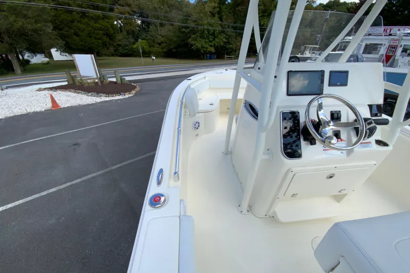 Slide: The Image of 2025 Cobia 220 Center Console boat with modern dashboard and steering wheel. - 21