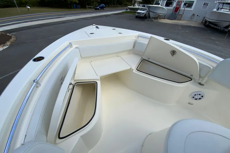 Slide: The Image of 2025 Cobia 220 Center Console boat interior with storage compartments and seating. - 23