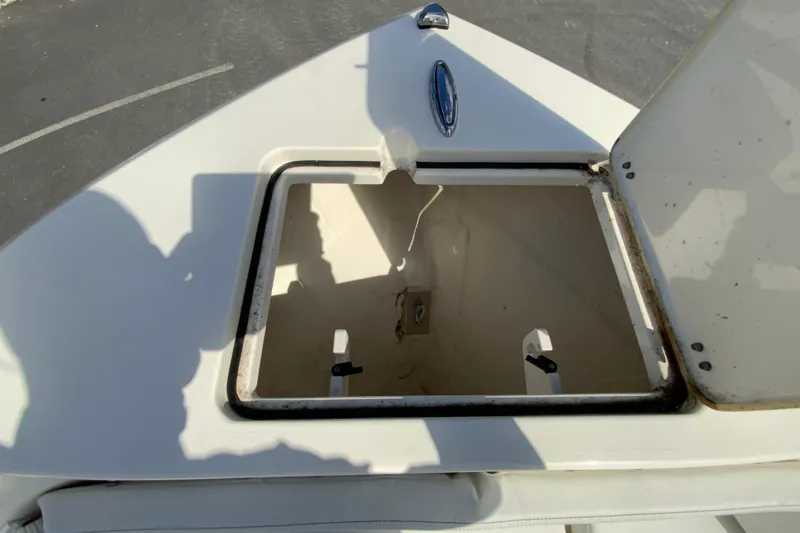 Slide: The Image of Open storage compartment on 2025 Cobia 220 Center Console boat deck. - 27