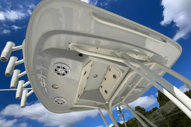 Slide: The Image of 2025 Cobia 220 Center Console boat's underside view against blue sky. - 35