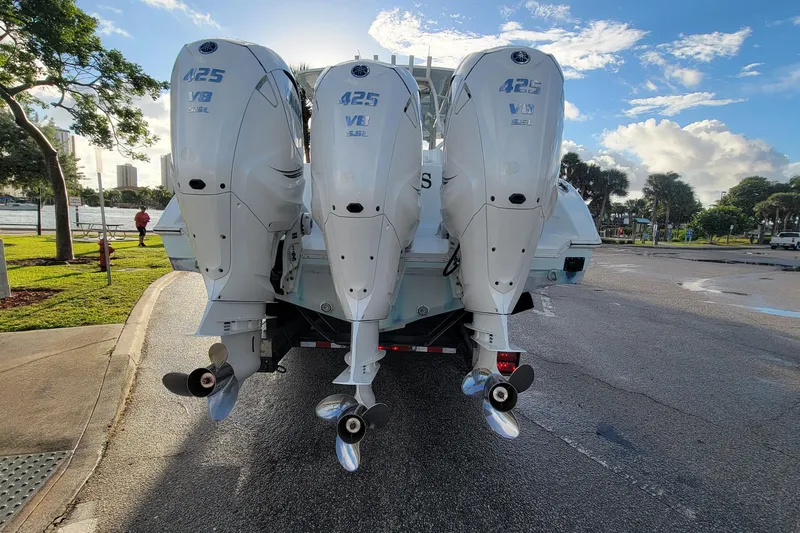 Slide: The Image of 2022 Yellowfin 42 Offshore boat with triple Yamaha 425 V8 engines, parked near waterfront. - 10