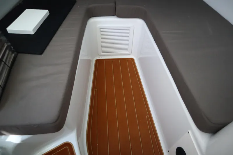 Slide: The Image of 2022 Yellowfin 42 Offshore cabin interior with cushioned seating and wood-style flooring. - 22