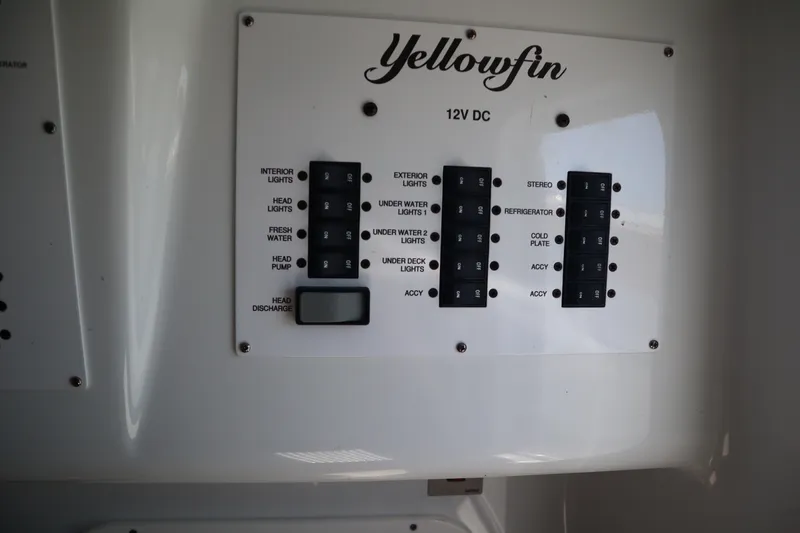Slide: The Image of Control panel of a 2022 Yellowfin 42 Offshore boat, featuring various switches and labels. - 26