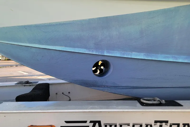 Slide: The Image of 2022 Yellowfin 42 Offshore boat hull on trailer, showcasing side view and propeller detail. - 3