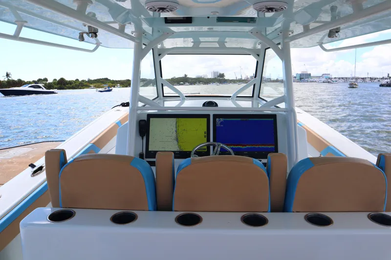 Slide: The Image of 2022 Yellowfin 42 Offshore boat interior with navigation screens and seating. - 34