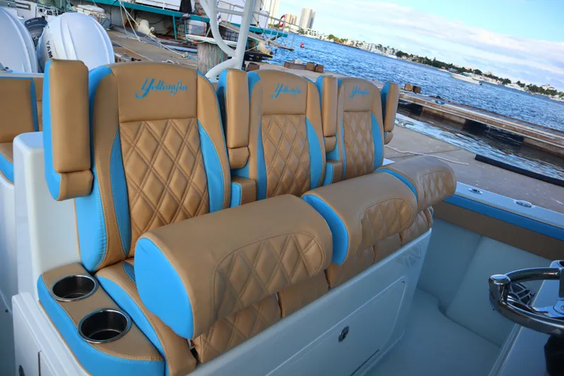Slide: The Image of Luxurious seating on 2022 Yellowfin 42 Offshore boat with tan and blue upholstery. - 50