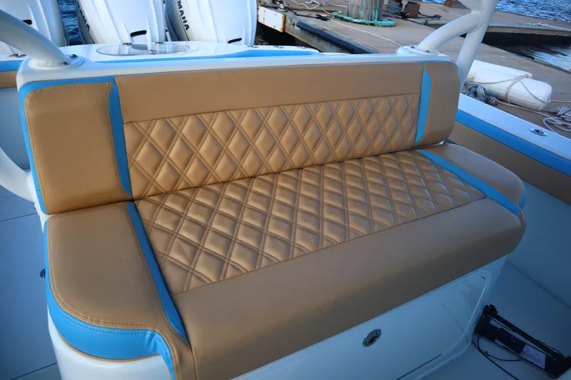 Slide: The Image of Luxurious tan and blue seating on 2022 Yellowfin 42 Offshore boat. - 53