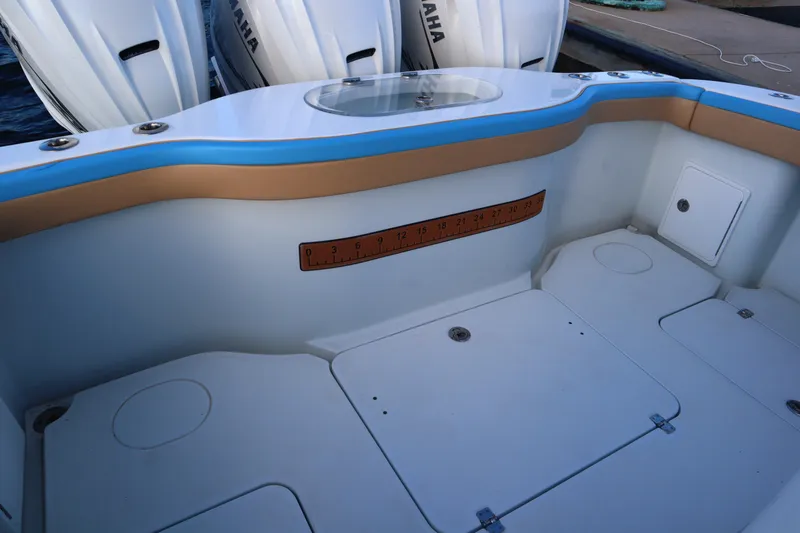 Slide: The Image of 2022 Yellowfin 42 Offshore boat interior with Yamaha engines and measuring ruler. - 54