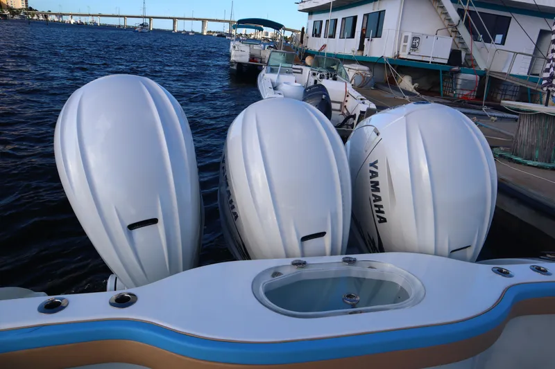 Slide: The Image of 2022 Yellowfin 42 Offshore boat with triple Yamaha outboard engines docked by the water. - 55