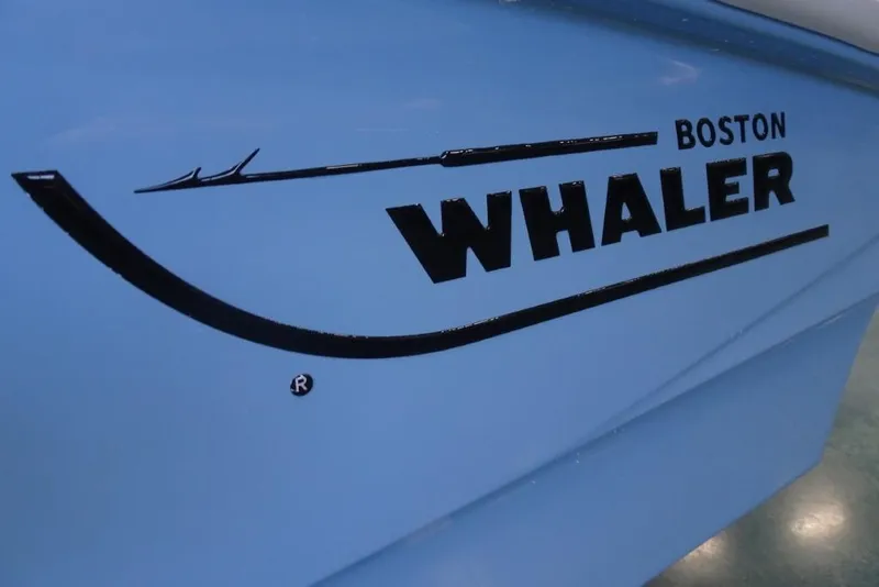 Slide: The Image of 2026 Boston Whaler 130 Super Sport logo on blue boat hull. - 6