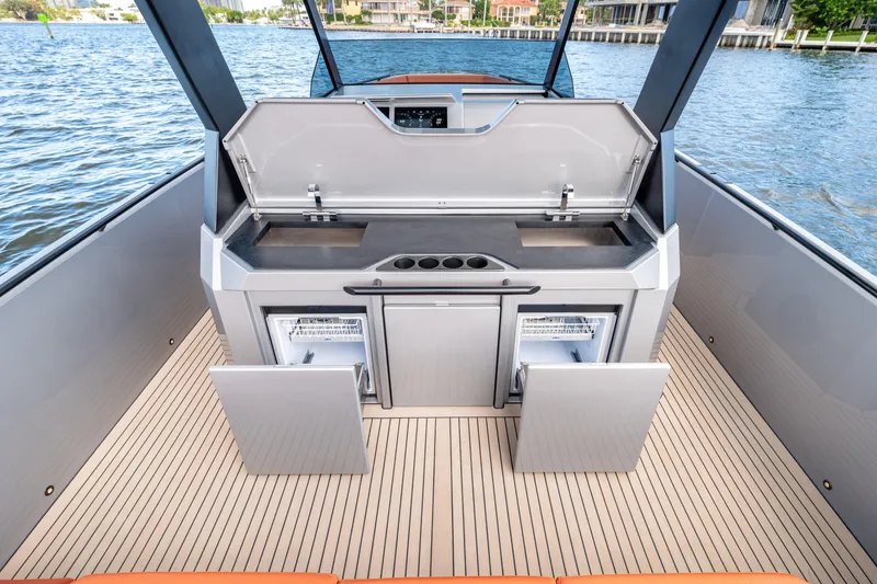 Slide: The Image of 2023 Vanquish Yachts Sports Line Outboard with open deck kitchen and storage compartments. - 10
