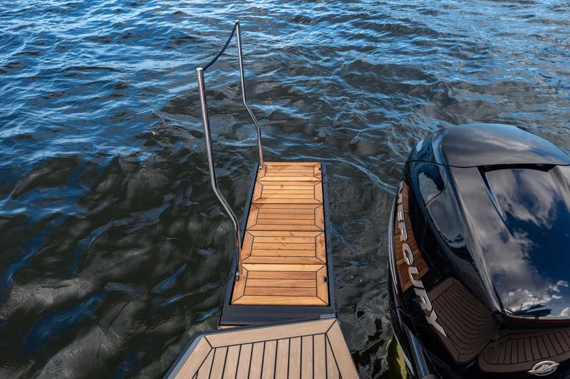 Slide: The Image of 2023 Vanquish Yachts Sports Line Outboard with wooden deck and outboard motor on water. - 12