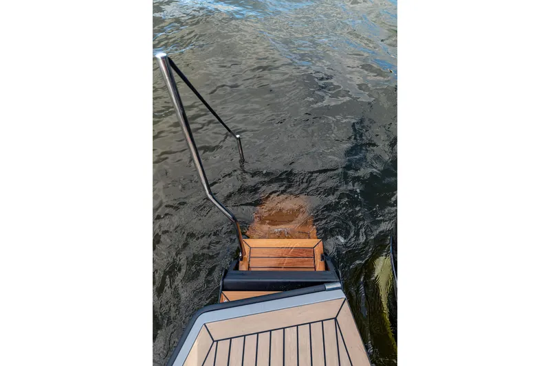 Slide: The Image of 2023 Vanquish Yachts Sports Line Outboard swim platform with ladder in water. - 13