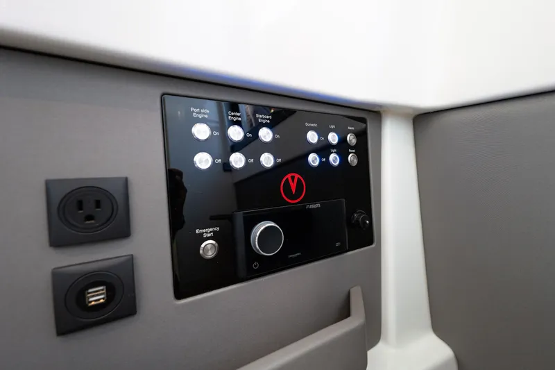Slide: The Image of Control panel of 2023 Vanquish Yachts Sports Line Outboard with buttons and USB ports. - 17