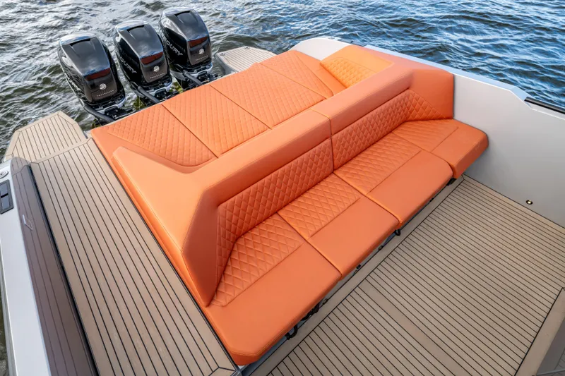 Slide: The Image of 2023 Vanquish Yachts Sports Line Outboard with orange seating and triple outboard engines. - 4