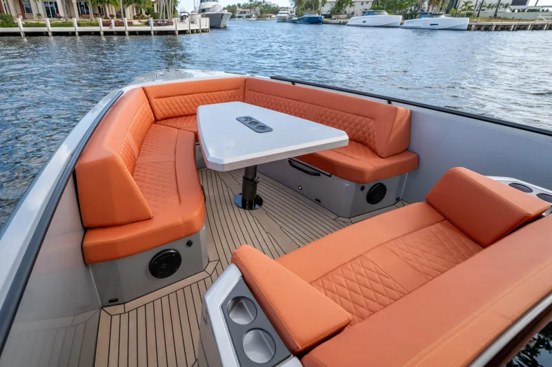 Slide: The Image of Luxurious 2023 Vanquish Yachts Sports Line Outboard with orange seating and sleek design. - 5