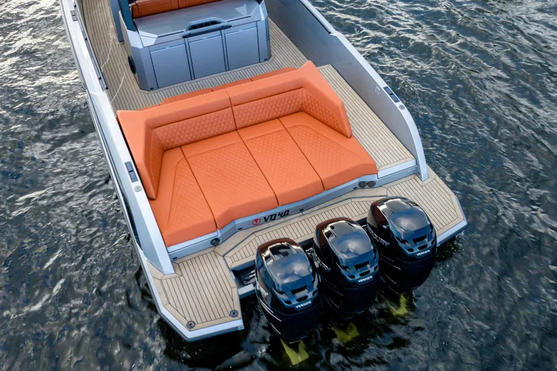 Slide: The Image of 2023 Vanquish Yachts Sports Line Outboard with orange seating and triple outboard motors. - 6