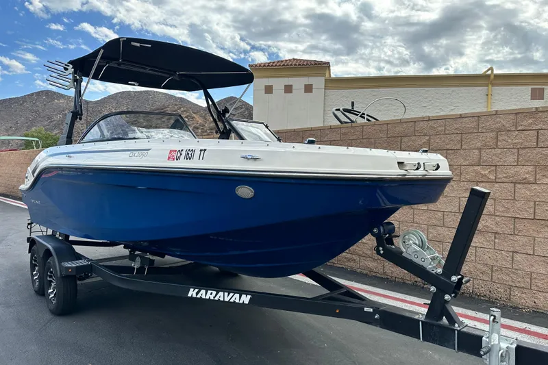 Slide: The Image of 2021 Bayliner DX 2050 boat interior with seating and open windshield. - 10