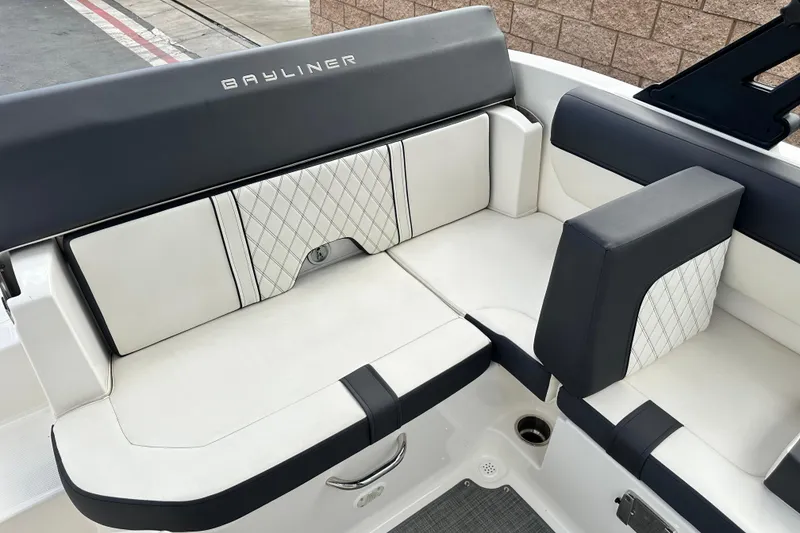 Slide: The Image of 2021 Bayliner DX 2050 boat interior with cushioned seating and cup holders. - 15