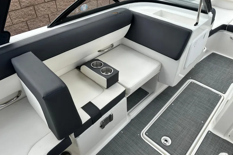 Slide: The Image of 2021 Bayliner DX 2050 boat storage compartment with gray flooring. - 16