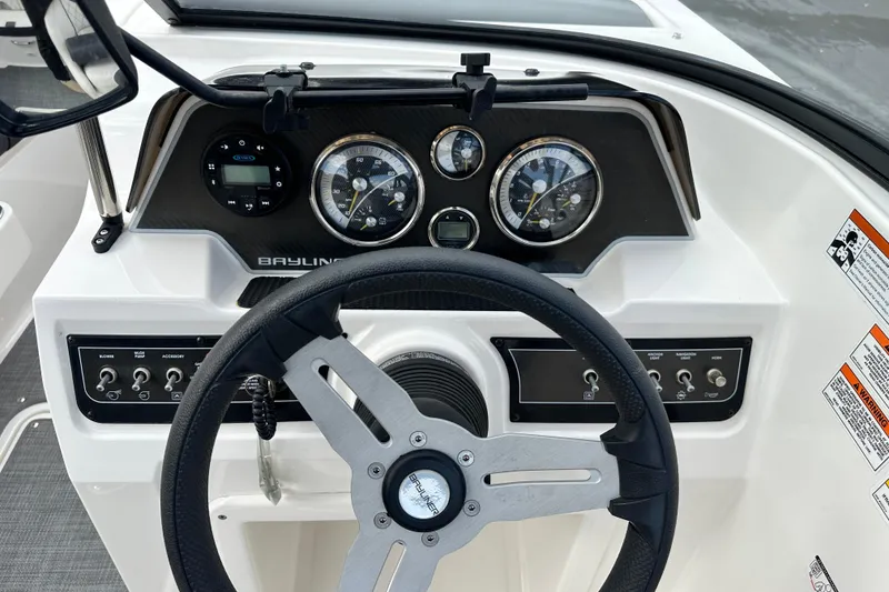 Slide: The Image of 2021 Bayliner DX 2050 dashboard with steering wheel and instrument panel. - 18