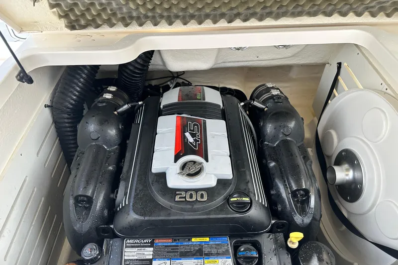 Slide: The Image of Trailer wheels of a 2021 Bayliner DX 2050 boat on pavement. - 23