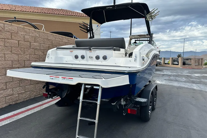 Slide: The Image of 2021 Bayliner DX 2050 boat on Karavan trailer, parked outdoors. - 3