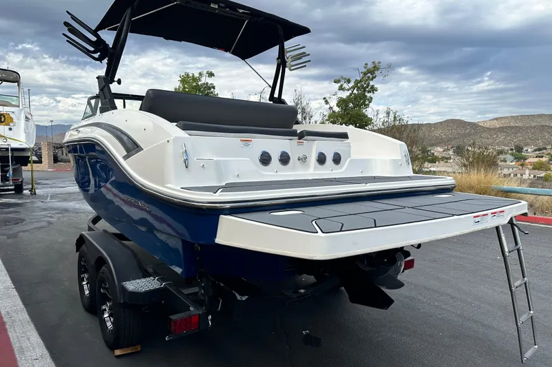 Slide: The Image of 2021 Bayliner DX 2050 boat rear view with swim platform and ladder. - 5