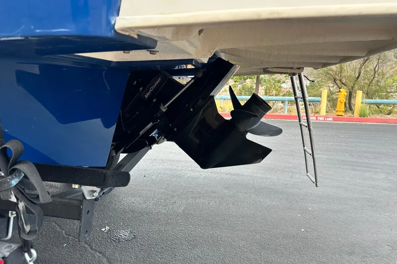 Slide: The Image of 2021 Bayliner DX 2050 boat with swim platform and ladder, parked on a trailer. - 6