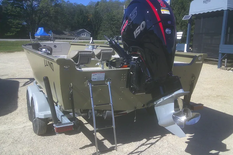 Slide: The Image of 2026 Lund 2075 Alaskan Tiller boat with powerful outboard motor on trailer. - 11